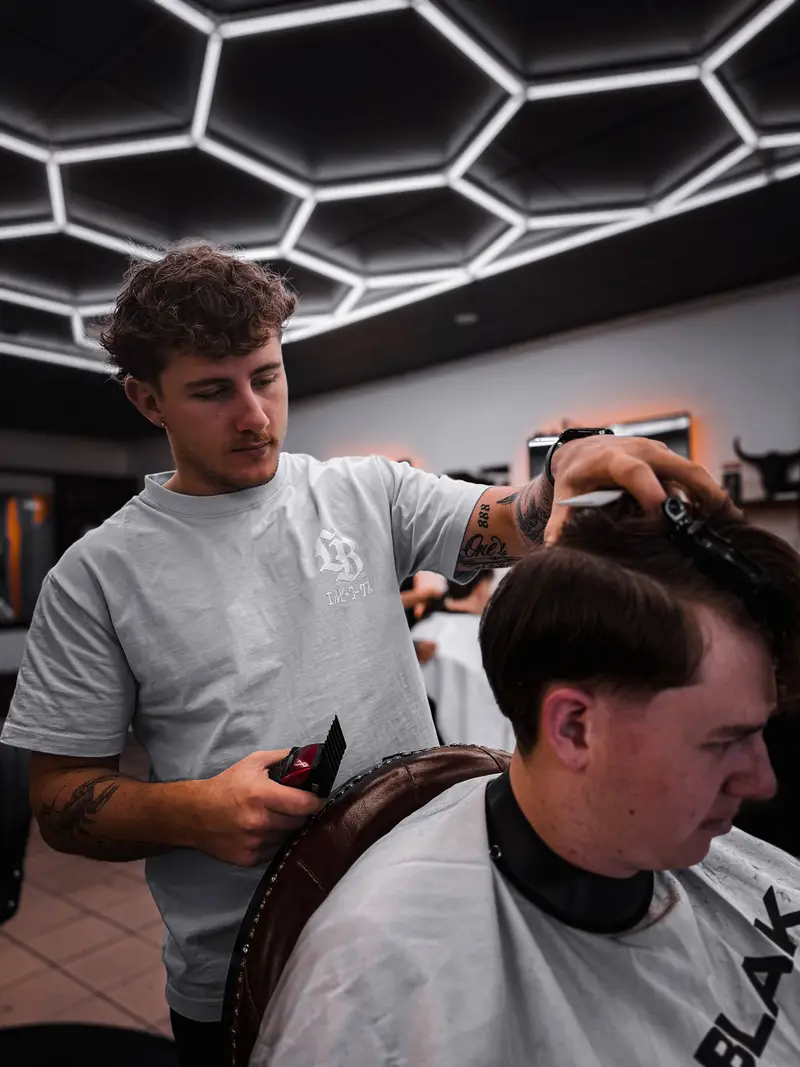 Taij cutting hair at Barber Collective Buderim