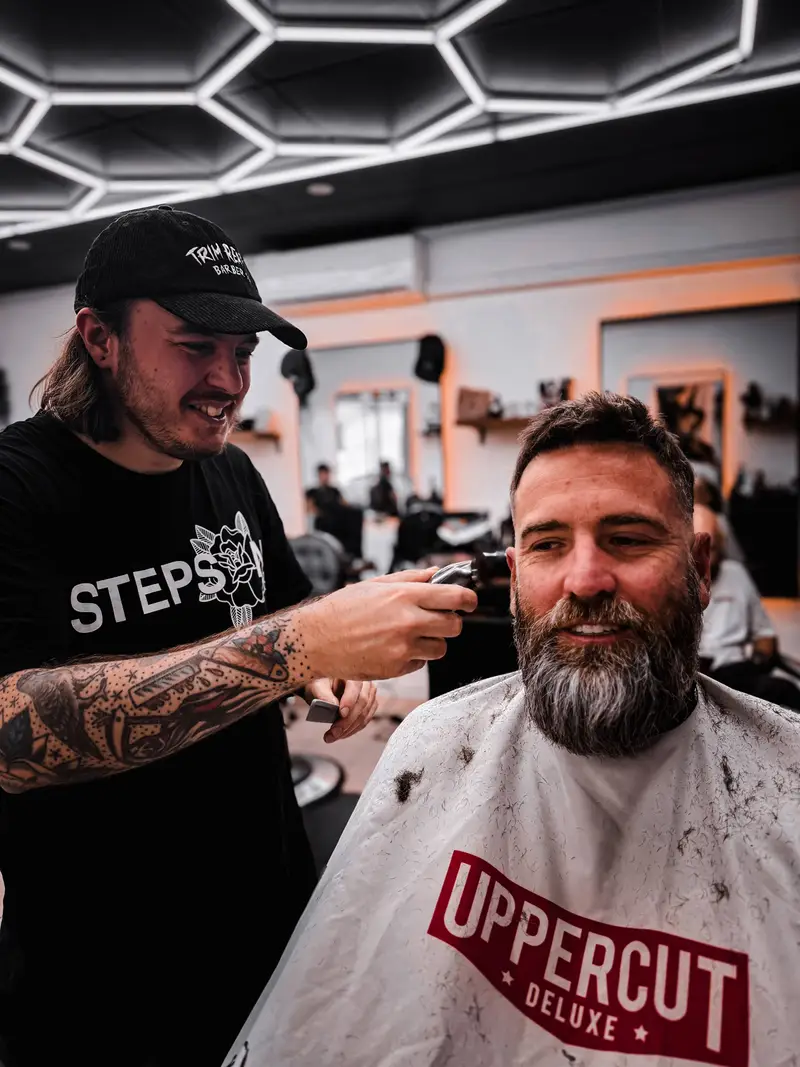 Tom cutting hair at Barber Collective Buderim